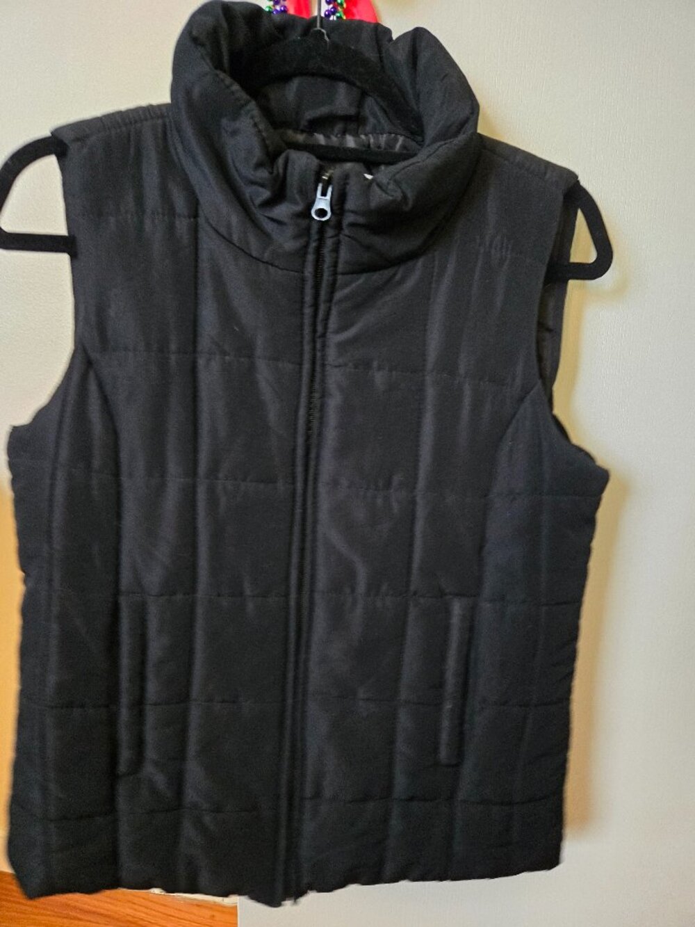 Black sleeveless quilted puffer vest